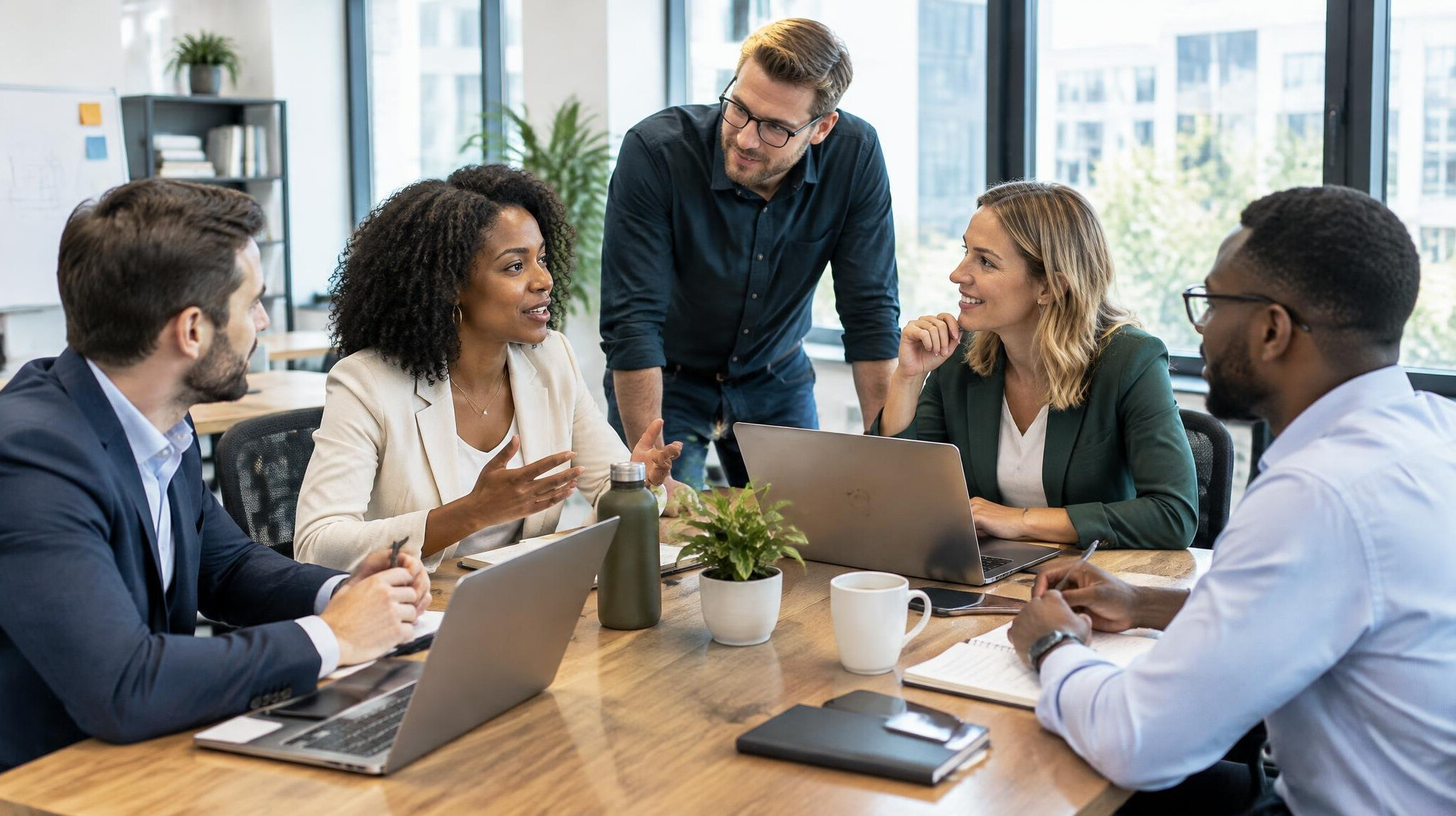Group of colleagues discussing business plans around a table