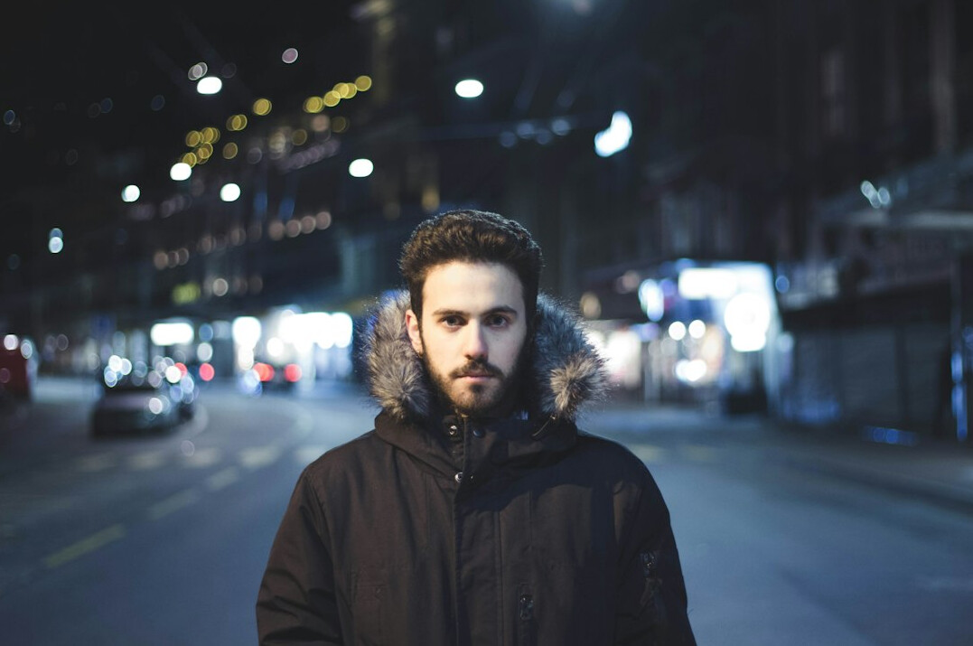 Bearded man in a dark jacket looking at the camera