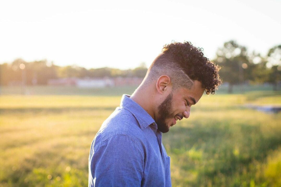 Smiling man with short hair in a casual shirt