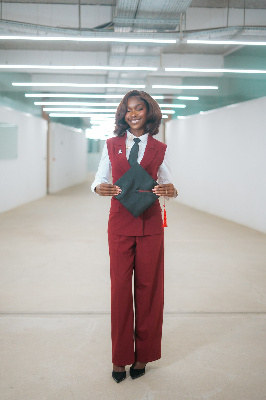 Smiling businesswoman in a blazer holding a folder